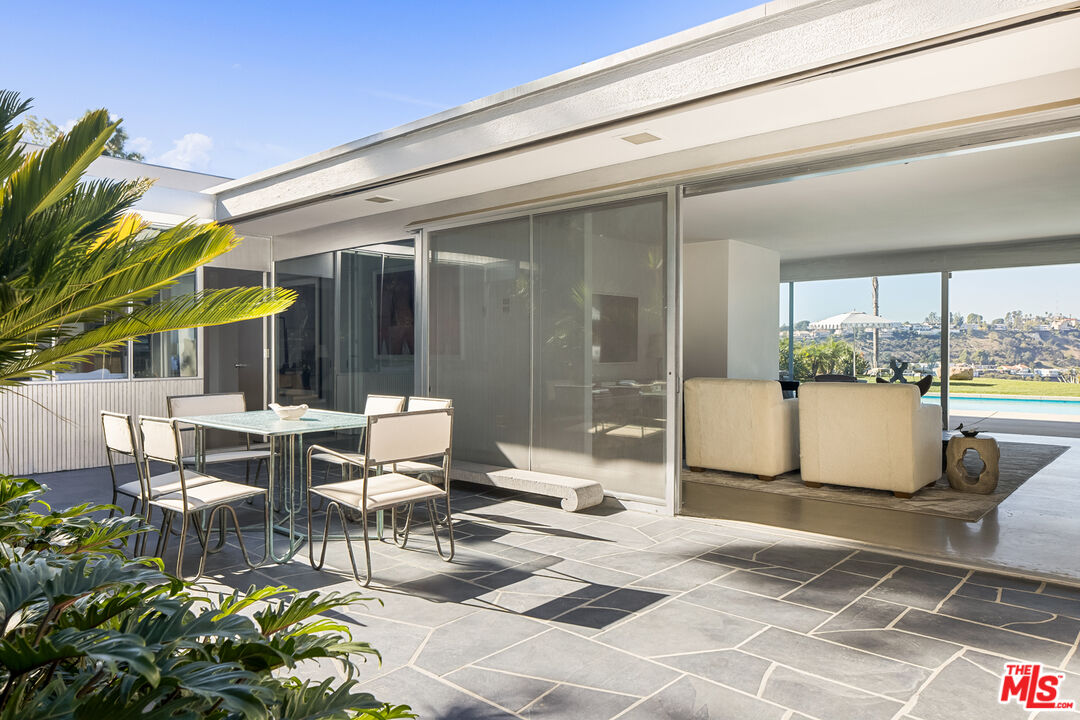 2456 Astral Drive Los Angeles, CA 90046 - Photo 8 of 33 a view of a patio with table and chairs and potted plants
