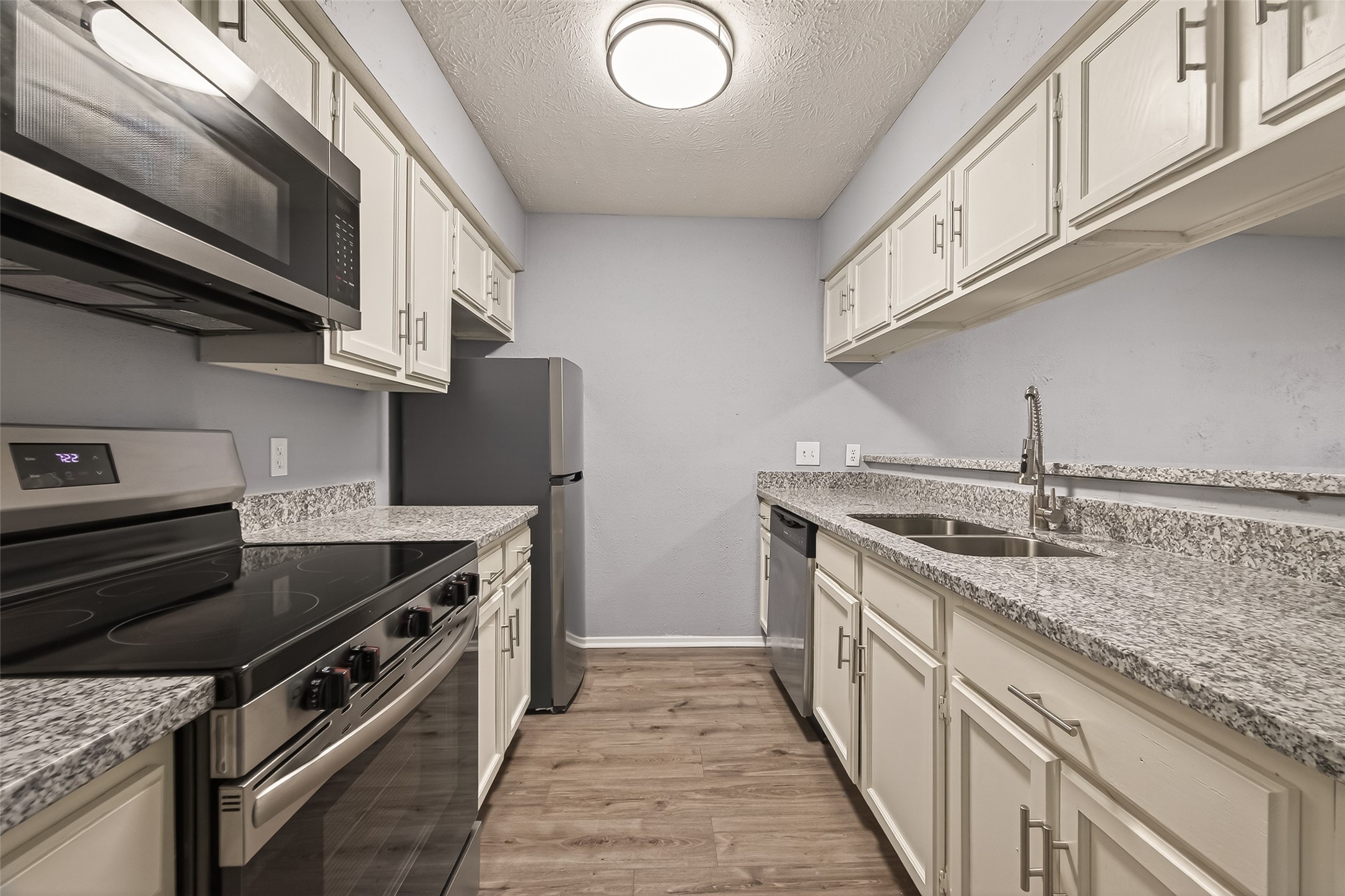 7313 Gulf Freeway, Unit 904 Houston, TX 77017 - Photo 15 of 27 a kitchen with stainless steel appliances granite countertop a stove and a sink