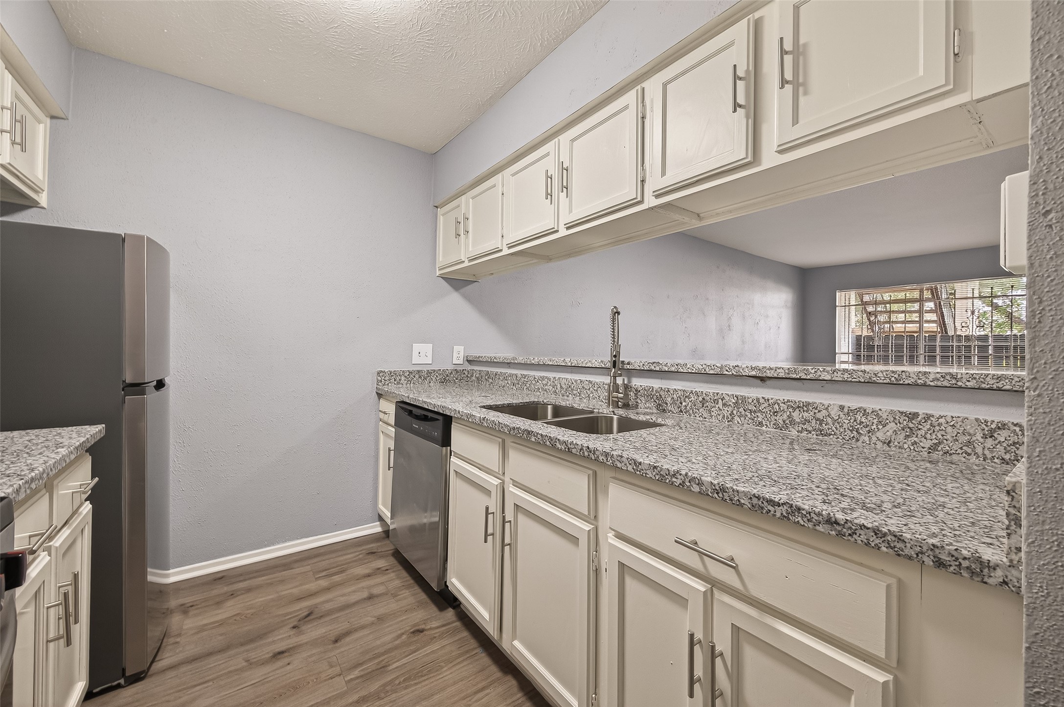 7313 Gulf Freeway, Unit 904 Houston, TX 77017 - Photo 16 of 27 a kitchen with stainless steel appliances granite countertop a sink and a refrigerator