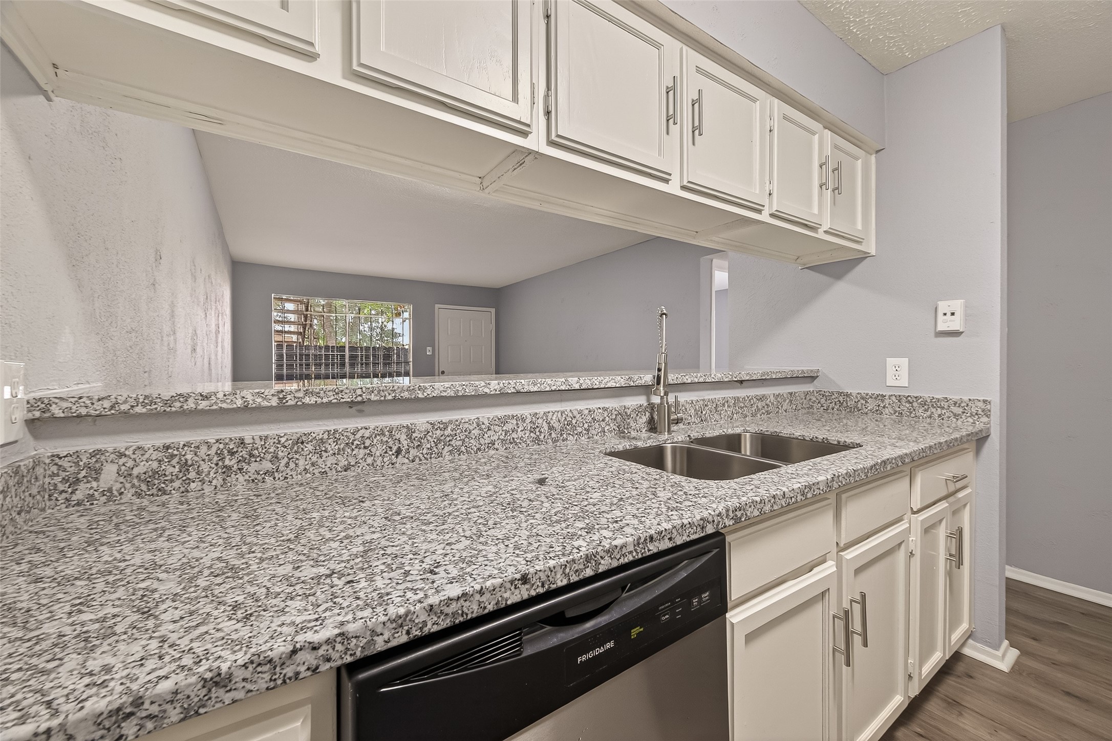 7313 Gulf Freeway, Unit 904 Houston, TX 77017 - Photo 18 of 27 a kitchen with granite countertop a sink and cabinets