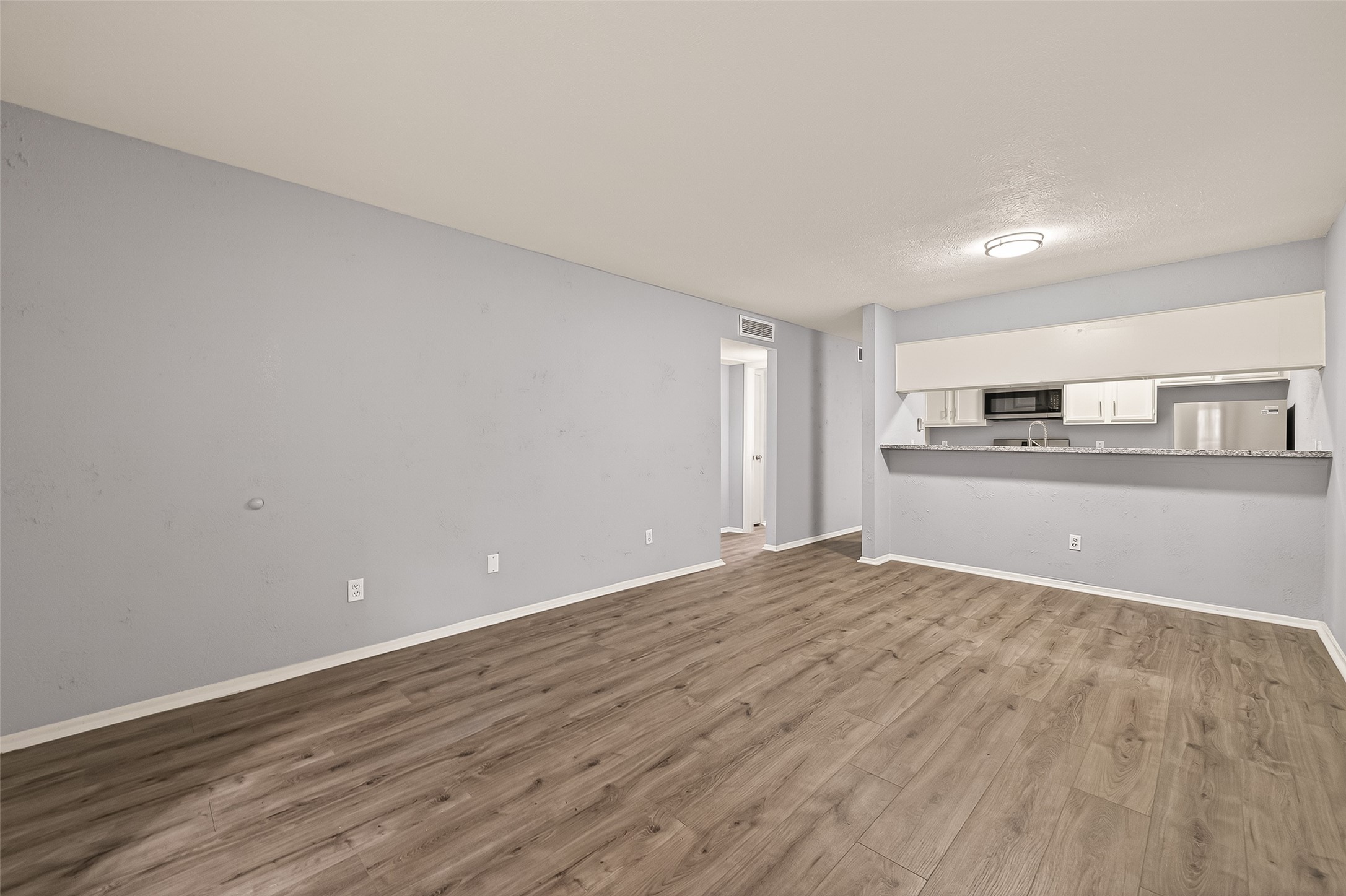 7313 Gulf Freeway, Unit 904 Houston, TX 77017 - Photo 2 of 27 a view of a kitchen with wooden floor and kitchen