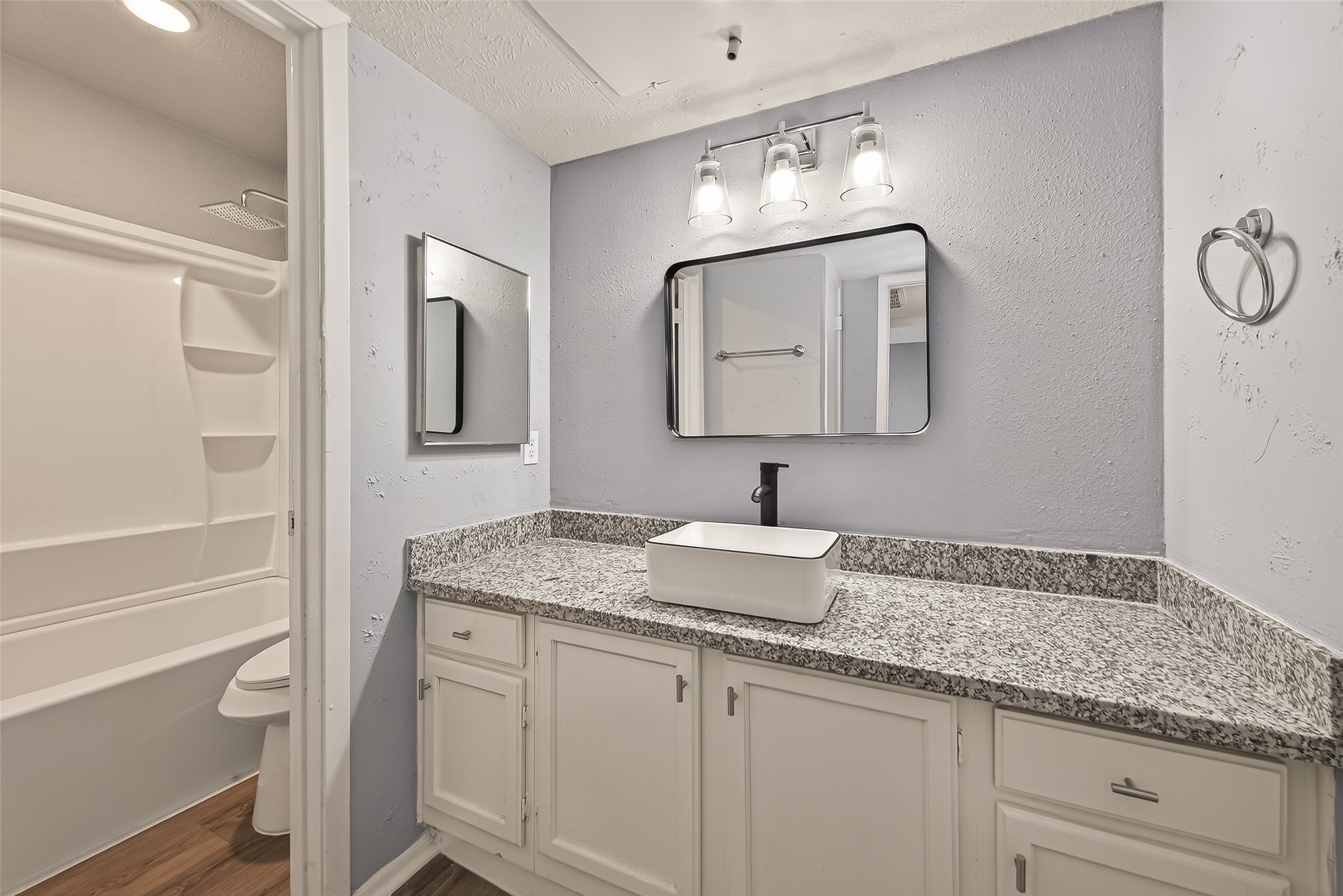 7313 Gulf Freeway, Unit 904 Houston, TX 77017 - Photo 22 of 27 a bathroom with a granite countertop sink and a mirror