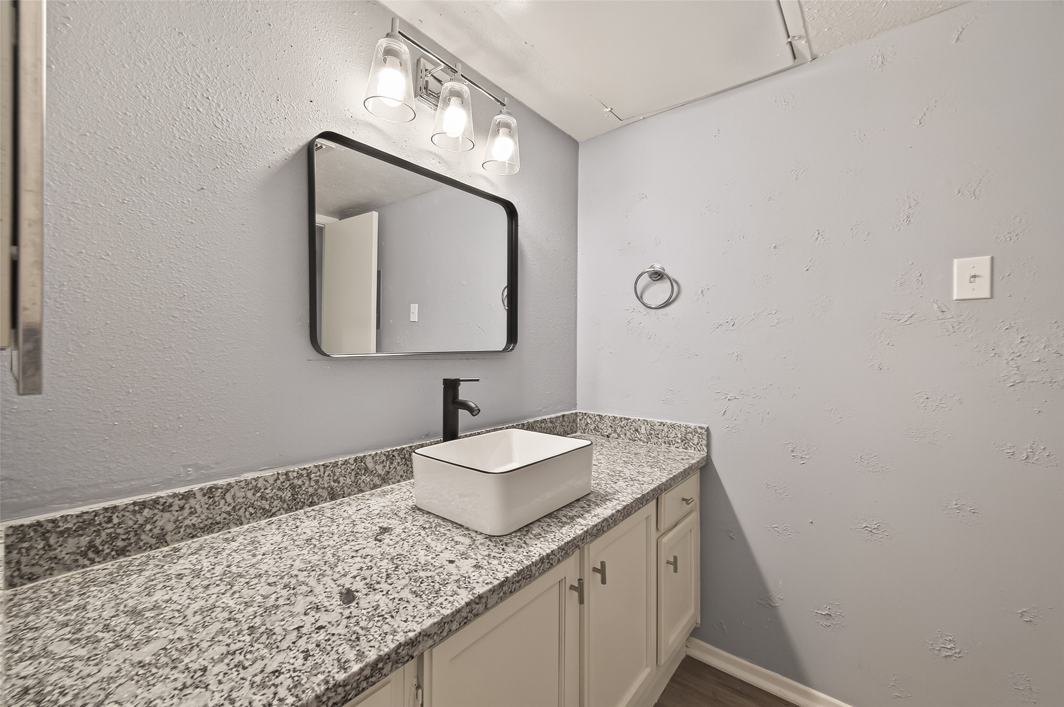 7313 Gulf Freeway, Unit 904 Houston, TX 77017 - Photo 23 of 27 a bathroom with a granite countertop sink and a mirror
