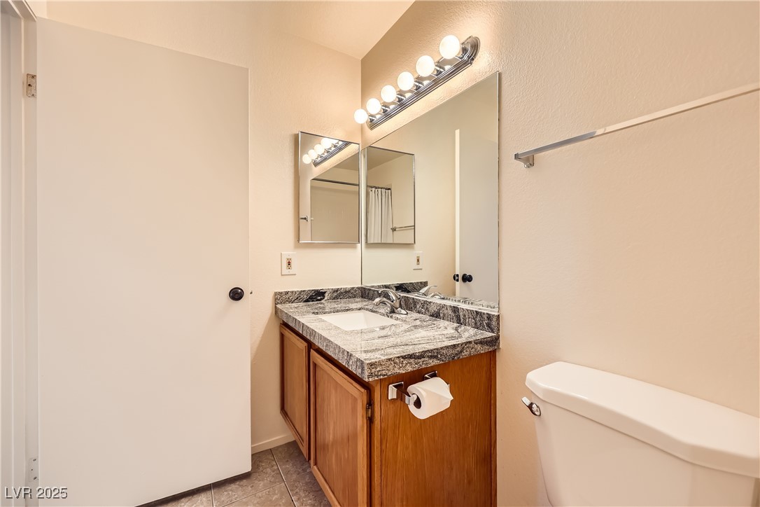 1575 West Warm Springs Road, Unit 1613 Henderson, NV 89014 - Photo 33 of 39 Half bath featuring tile patterned floors, toilet, and vanity