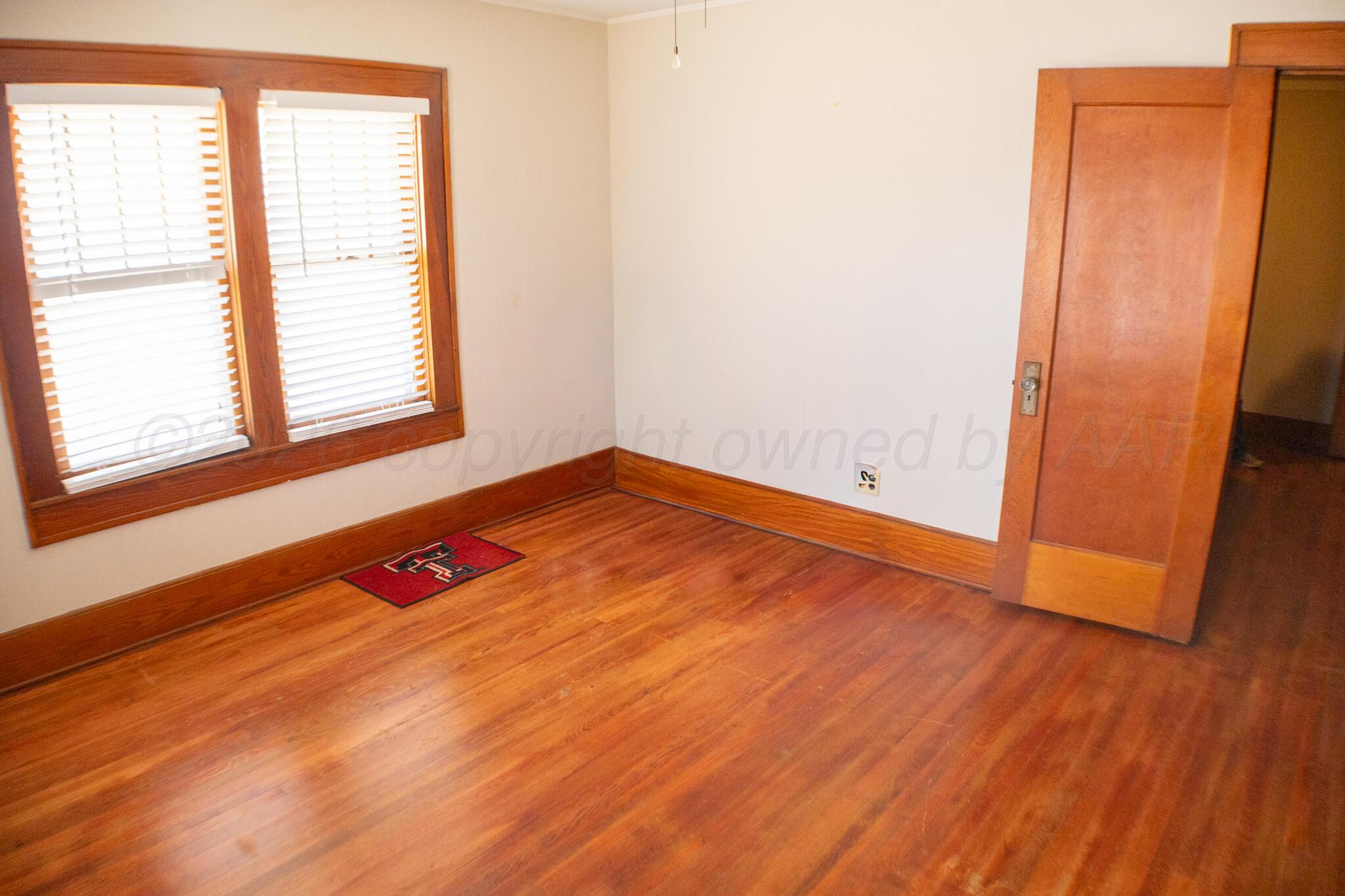 801 North Main Street McLean, TX 79057 - Photo 22 of 24 an empty room with wooden floor and windows