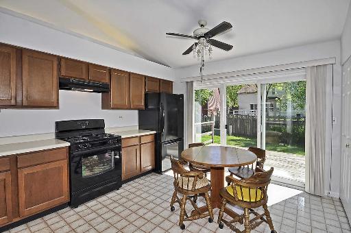 41 Bedford Road Mundelein, IL 60060 - Photo 7 of 16 a kitchen with granite countertop stainless steel appliances a dining table and chairs