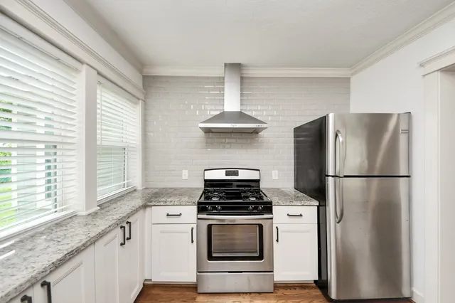 a kitchen with refrigerator and window