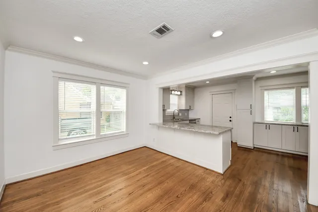 a view of a kitchen with a sink and a refrigerator