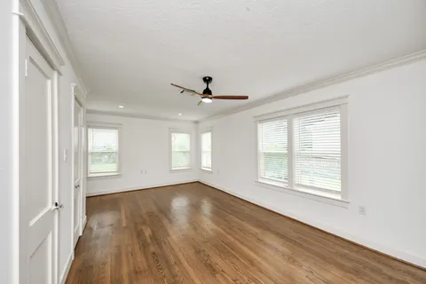 a view of a livingroom with wooden floor and a ceiling fan