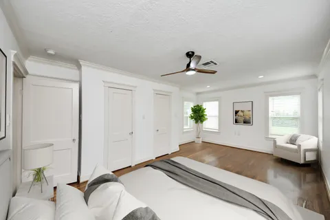 a bedroom with a bed and a potted plant