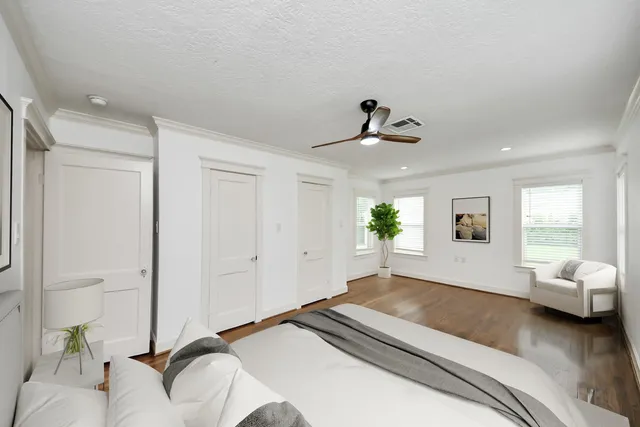 a bedroom with a bed and a potted plant