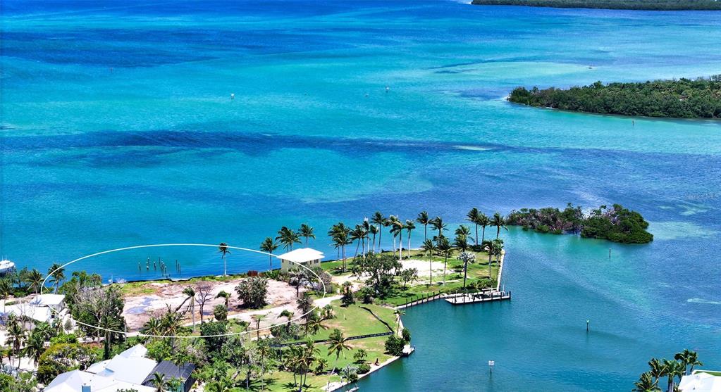 6516 Bayou Hammock Road Longboat Key, FL 34228 - Photo 6 of 20 a view of a lake with lawn chairs