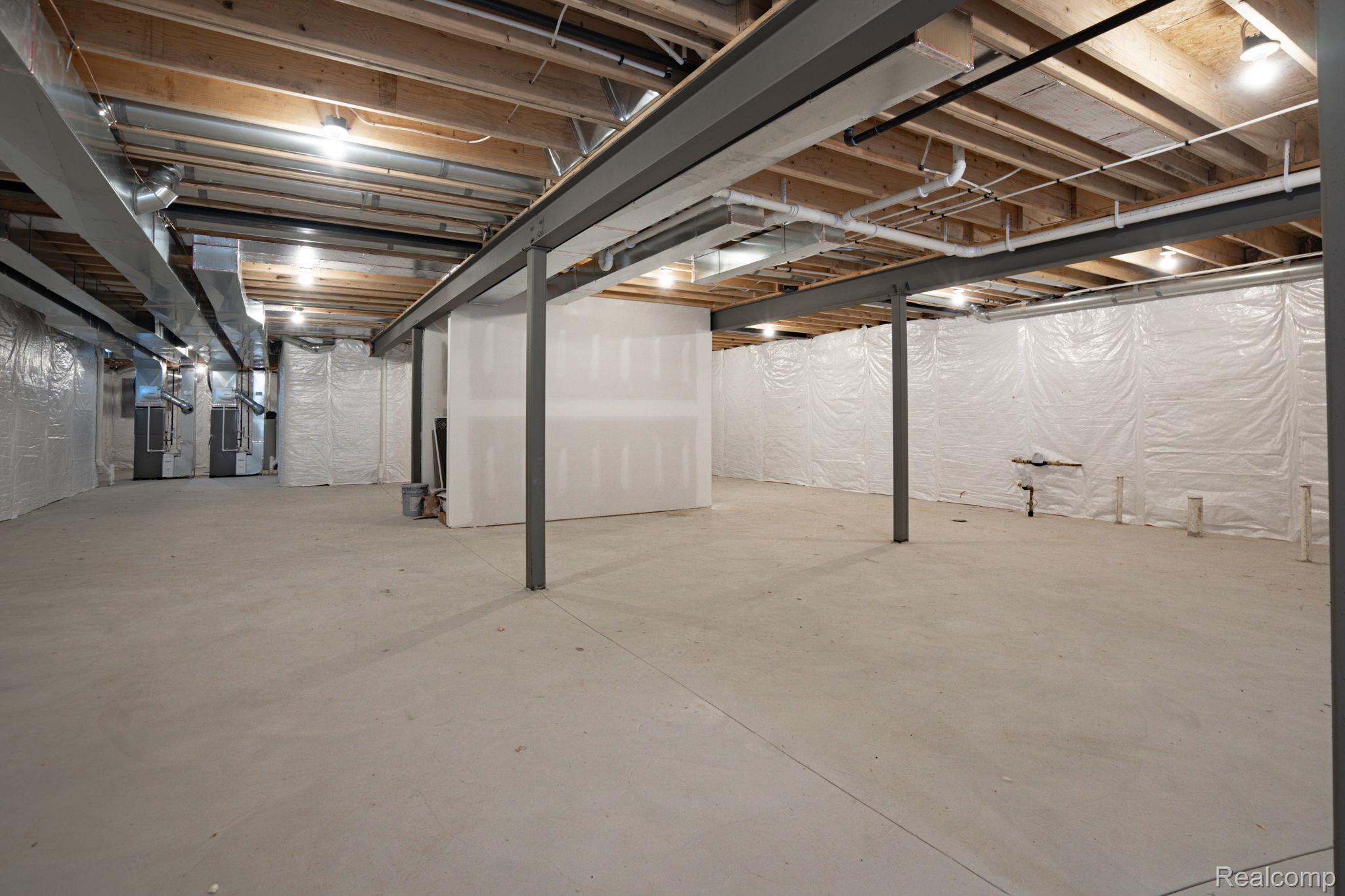 3836 Coachwood Lane Rochester, MI 48309 - Photo 82 of 82 Expansive unfinished basement featuring concrete flooring, exposed wood joists, and structural steel beams