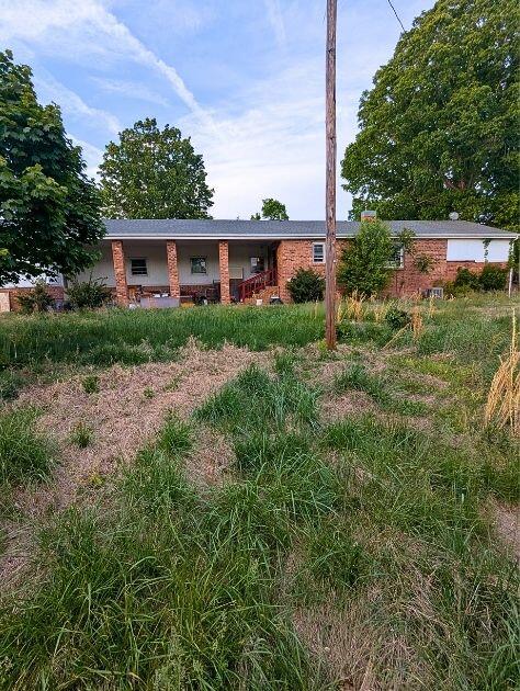 601 Farmers Mountain Road Gretna, VA 24557 - Photo 13 of 20 a view of a big yard in front of a brick house with large windows