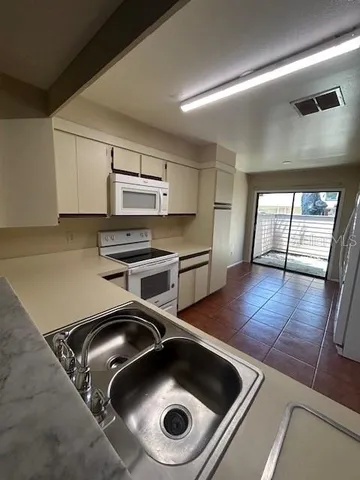 a kitchen with wooden floor and a sink