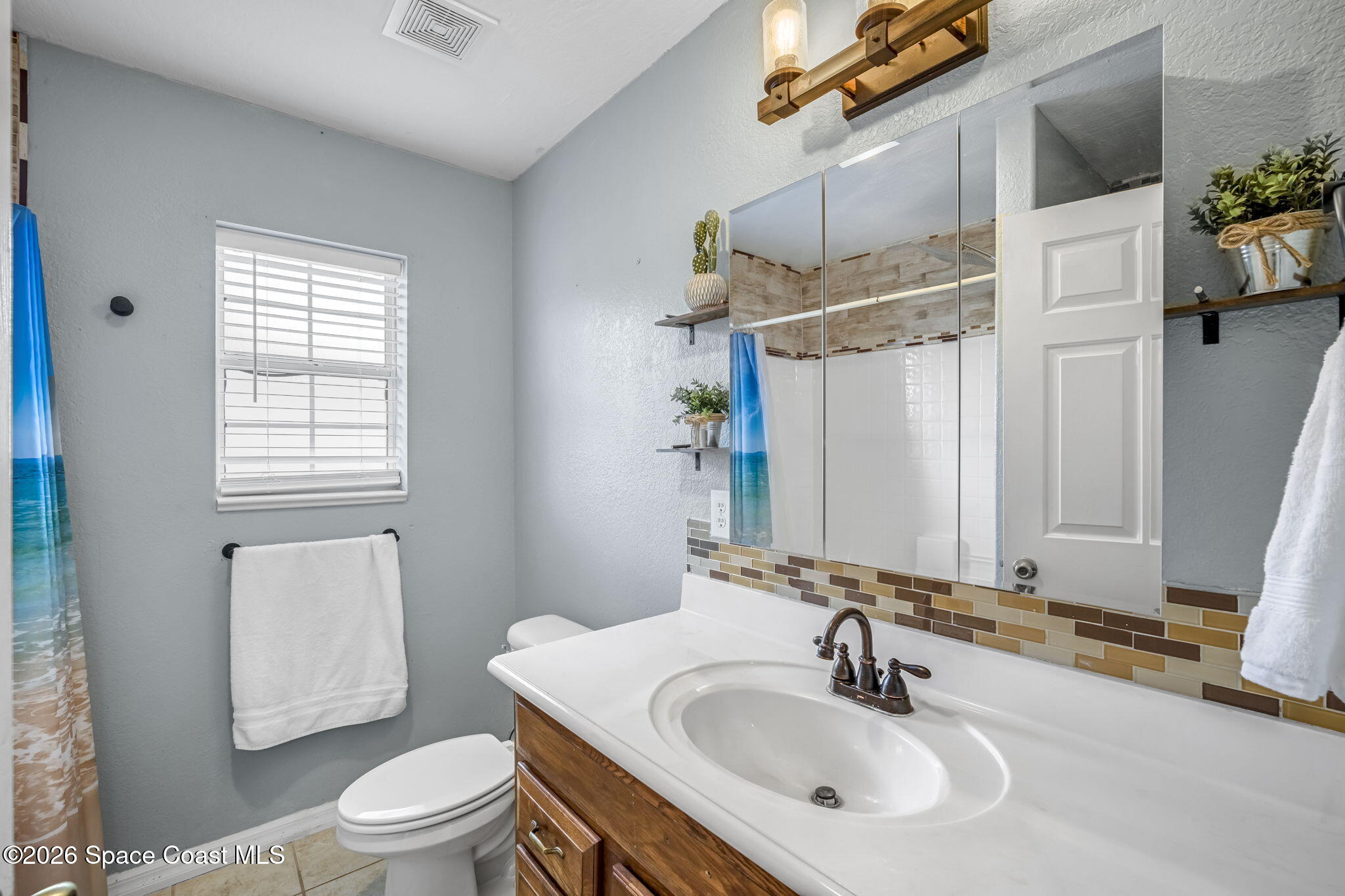 3404 Kilbee Street Mims, FL 32754 - Photo 20 of 30 a bathroom with a sink toilet and shower