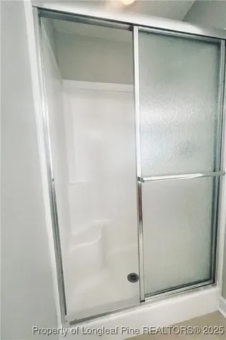 a bathroom with a glass shower door