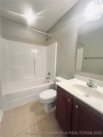 a bathroom with a sink a toilet a mirror and bathtub