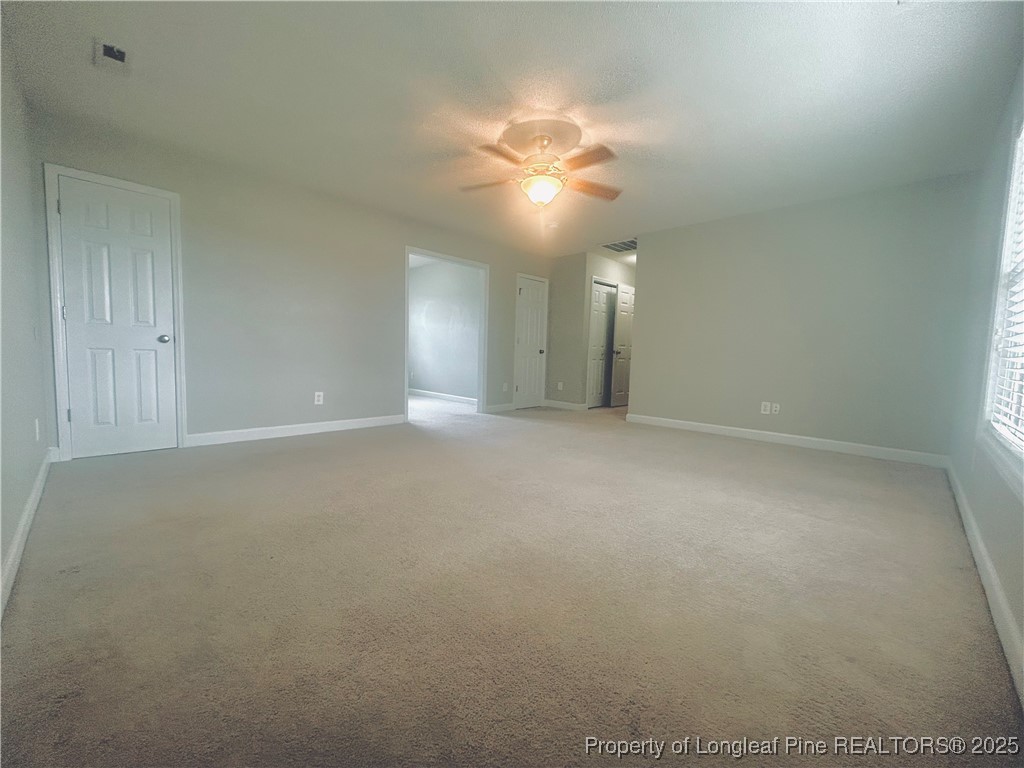 831 Northview Drive Sanford, NC 27332 - Photo 21 of 24 a view of an empty room with a chandelier fan