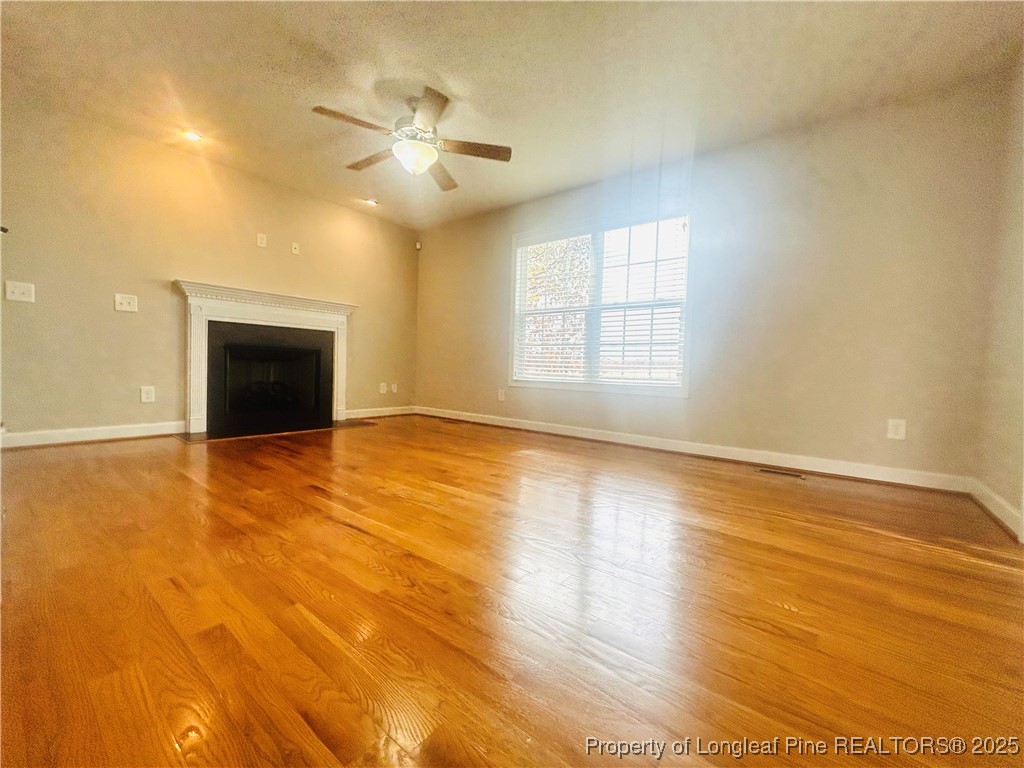 831 Northview Drive Sanford, NC 27332 - Photo 10 of 24 a view of an empty room with window and wooden floor