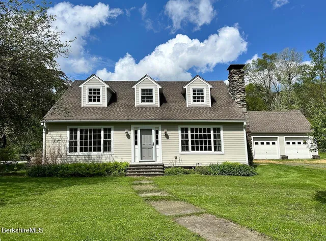 a front view of a house with a garden