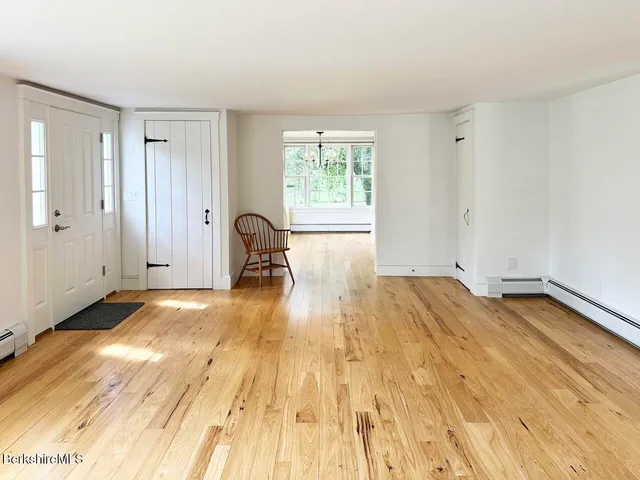 a view of a room with wooden floor and window