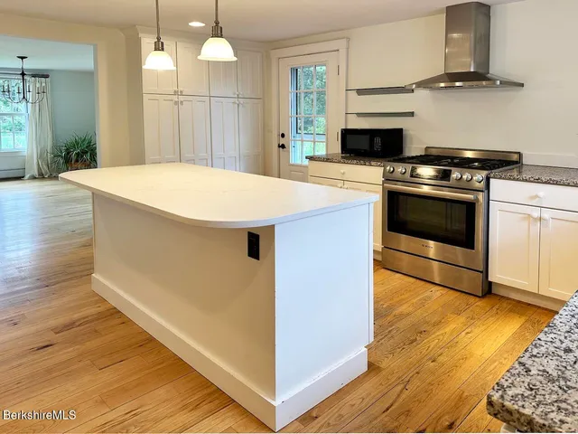 a kitchen with a stove a sink and a refrigerator