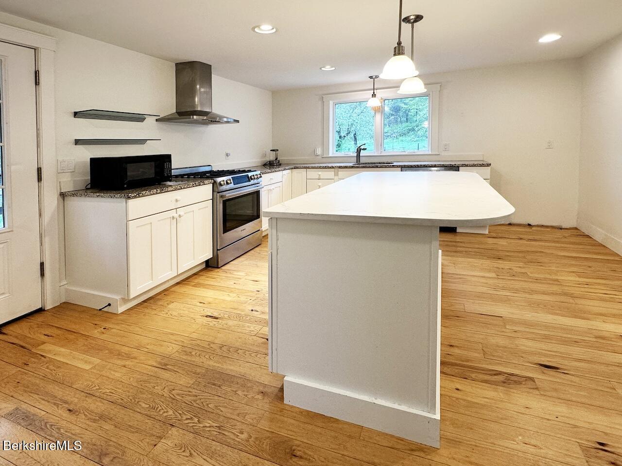 1786 South Undermountain Road Sheffield, MA 01257 - Photo 8 of 17 a kitchen with stainless steel appliances a stove sink and microwave