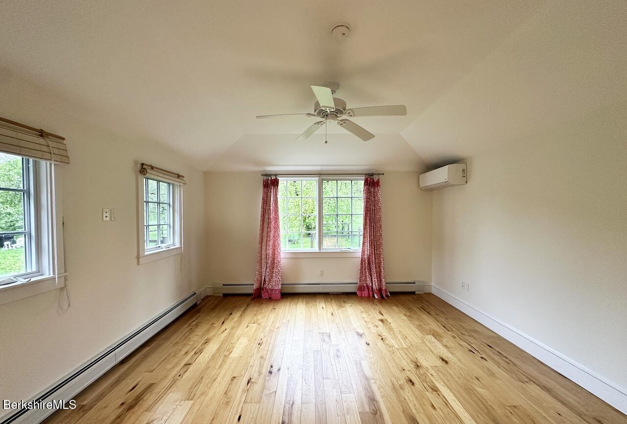1786 South Undermountain Road Sheffield, MA 01257 - Photo 9 of 17 an empty room with wooden floor and windows