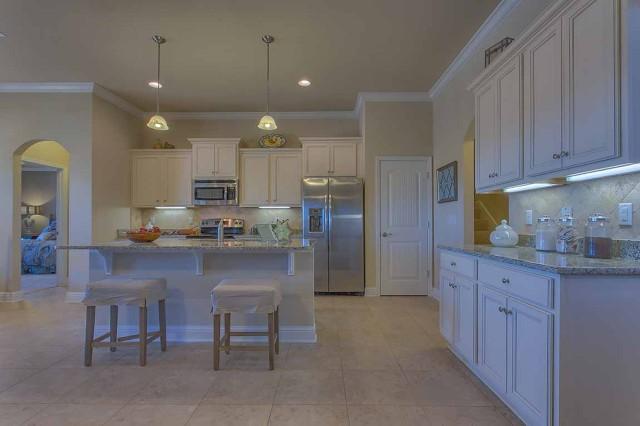 280 Maddox Street Santa Rosa Beach, FL 32459 - Photo 8 of 20 a kitchen with stainless steel appliances granite countertop a refrigerator a sink dishwasher a stove and a cabinets with wooden floor