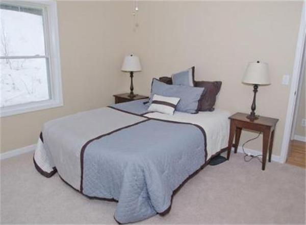 198 Ellis Road Westminster, MA 01473 - Photo 9 of 19 a bed room with a bed and a lamp