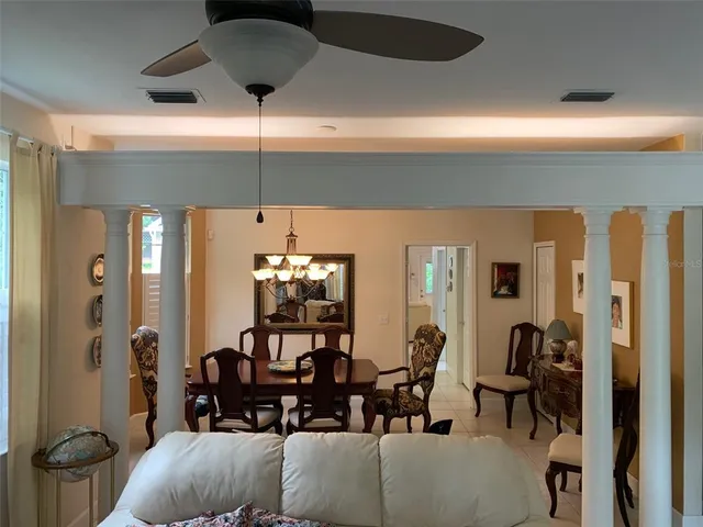 a living room with furniture and a chandelier