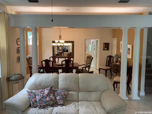 a living room with furniture and a large mirror