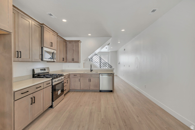 10999 South Freestone Road, Unit 111 South Jordan, UT 84009 - Photo 2 of 13 Kitchen with stainless steel appliances, light wood-style flooring, and recessed lighting