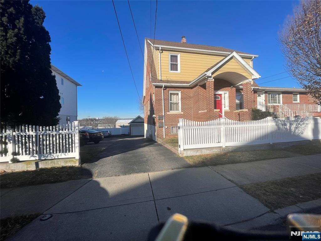 357 MacArthur Avenue, Unit 1 Garfield, NJ 07026 - Photo 2 of 11 a front view of a house with a yard