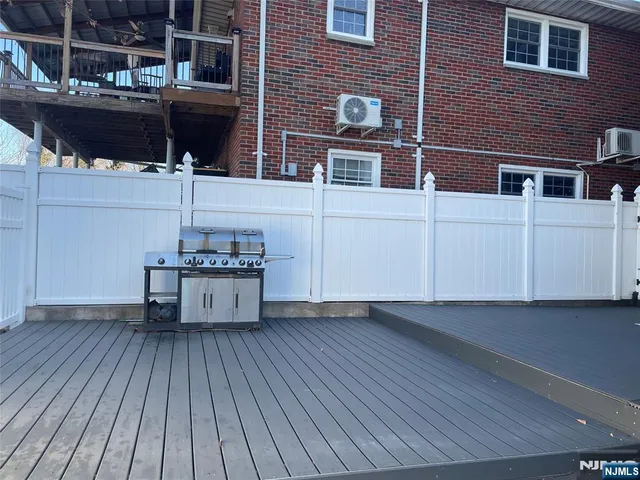 a view of a roof deck with table and chairs with wooden floor