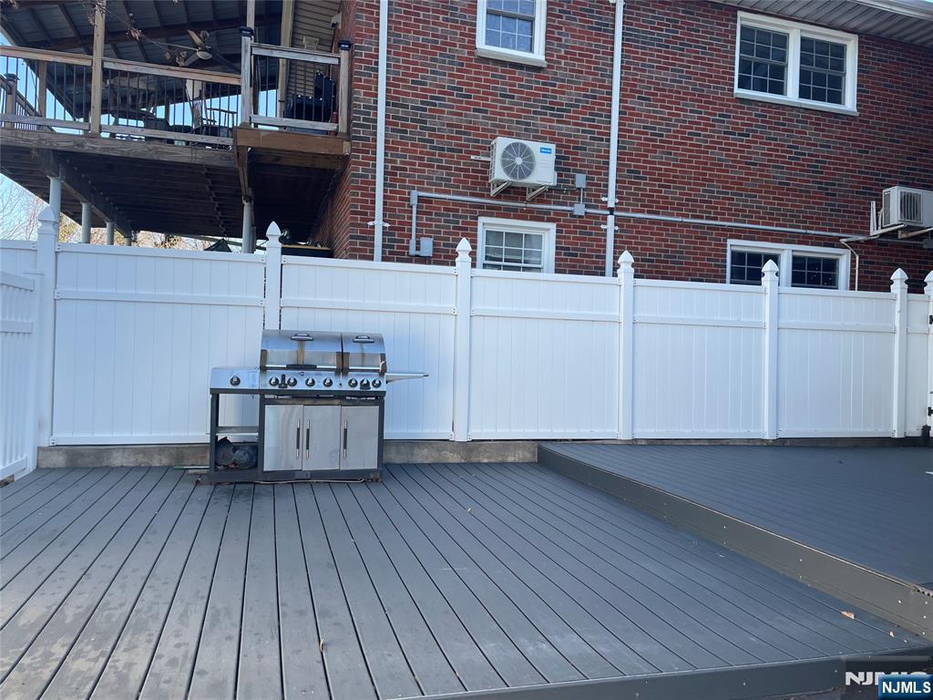 357 MacArthur Avenue, Unit 1 Garfield, NJ 07026 - Photo 5 of 11 a view of a roof deck with table and chairs with wooden floor