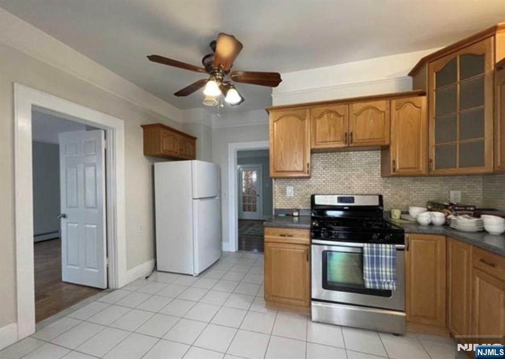 357 MacArthur Avenue, Unit 1 Garfield, NJ 07026 - Photo 6 of 11 a kitchen with a stove cabinets and a refrigerator
