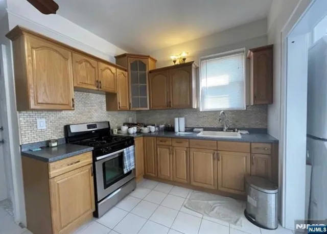 a kitchen with a sink stove and cabinets