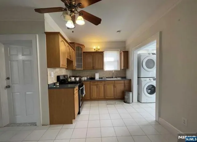 a kitchen with a refrigerator a stove top oven and cabinets