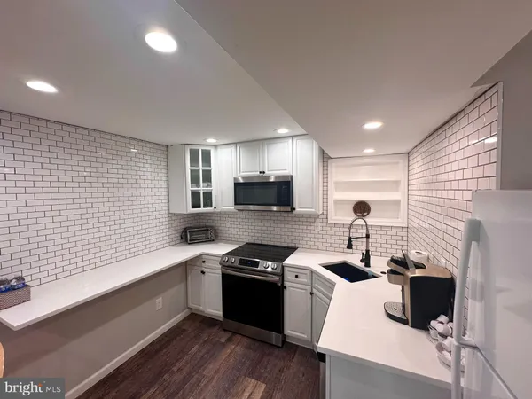 a kitchen with a sink cabinets and a window