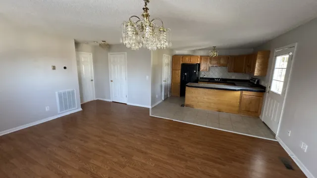 a view of a kitchen with a sink and cabinets