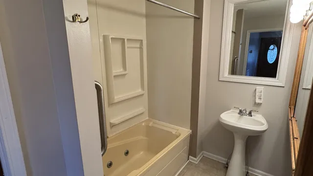 a bathroom with a sink a mirror and a bathtub