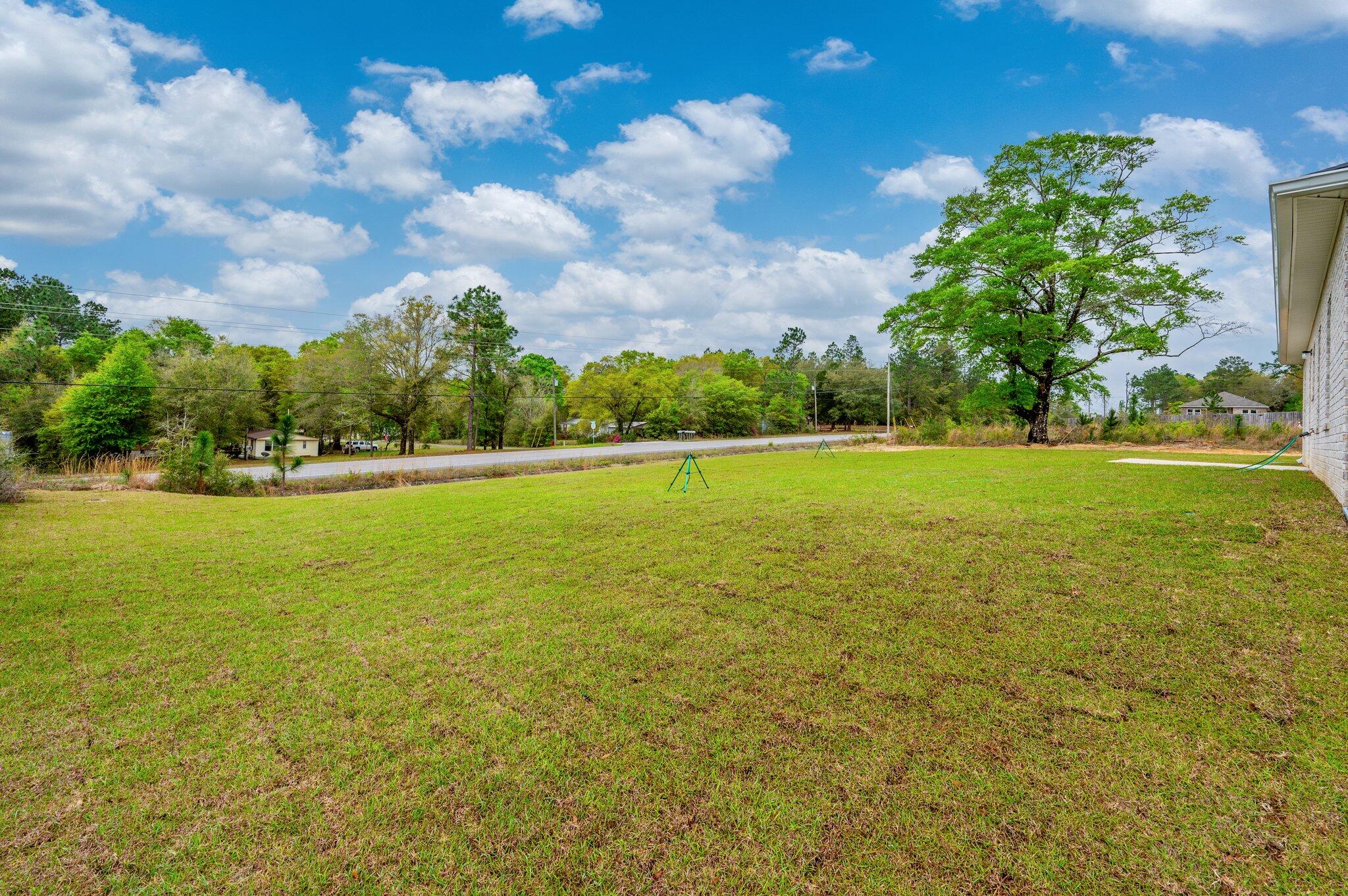 4071 Happy Trails Road Crestview, FL 32539 - Photo 34 of 35 a view of a green field with clear sky