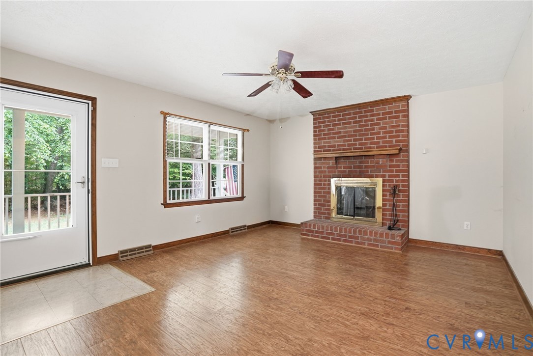 1917 Mahixon Road Manquin, VA 23106 - Photo 15 of 43 wooden floor fireplace and windows in an empty room