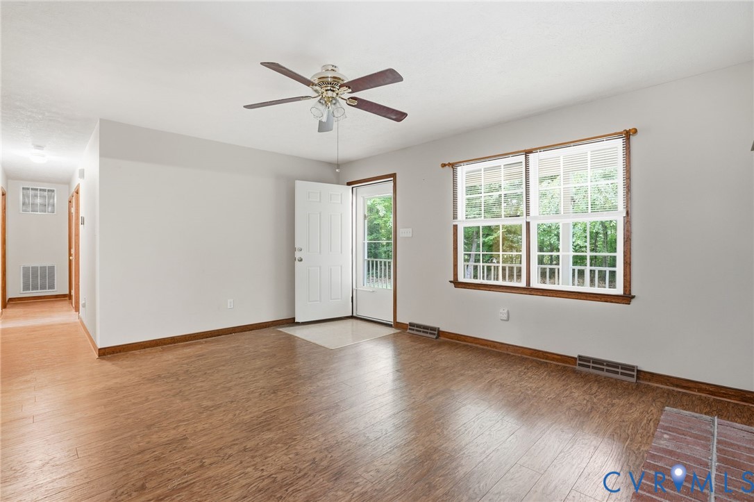 1917 Mahixon Road Manquin, VA 23106 - Photo 17 of 43 a view of an empty room with wooden floor and a window