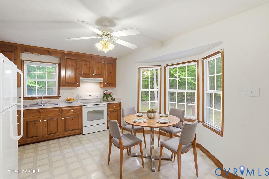1917 Mahixon Road Manquin, VA 23106 - Photo 20 of 43 a kitchen with a dining table chairs and stove