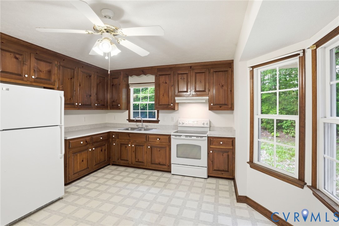 1917 Mahixon Road Manquin, VA 23106 - Photo 21 of 43 a kitchen with a stove a sink and a refrigerator