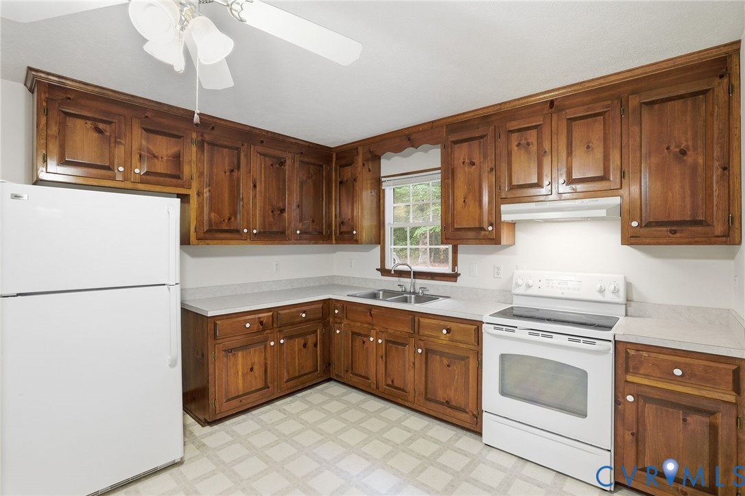 1917 Mahixon Road Manquin, VA 23106 - Photo 22 of 43 a kitchen with a stove sink and cabinets