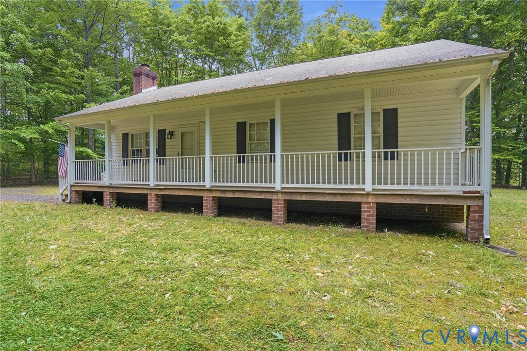 1917 Mahixon Road Manquin, VA 23106 - Photo 6 of 43 a view of a house with a backyard and deck